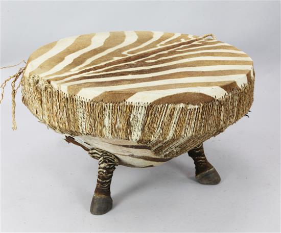 A zebra skin drum/coffee table(-)